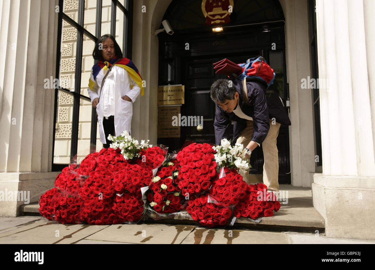 I sopravvissuti e i sostenitori hanno dato dei fiori sulle orde dell'ambasciata cinese nel centro di Londra, per celebrare il ventesimo anniversario della sanguinosa repressione contro gli attivisti a favore della democrazia da parte del governo cinese. Foto Stock