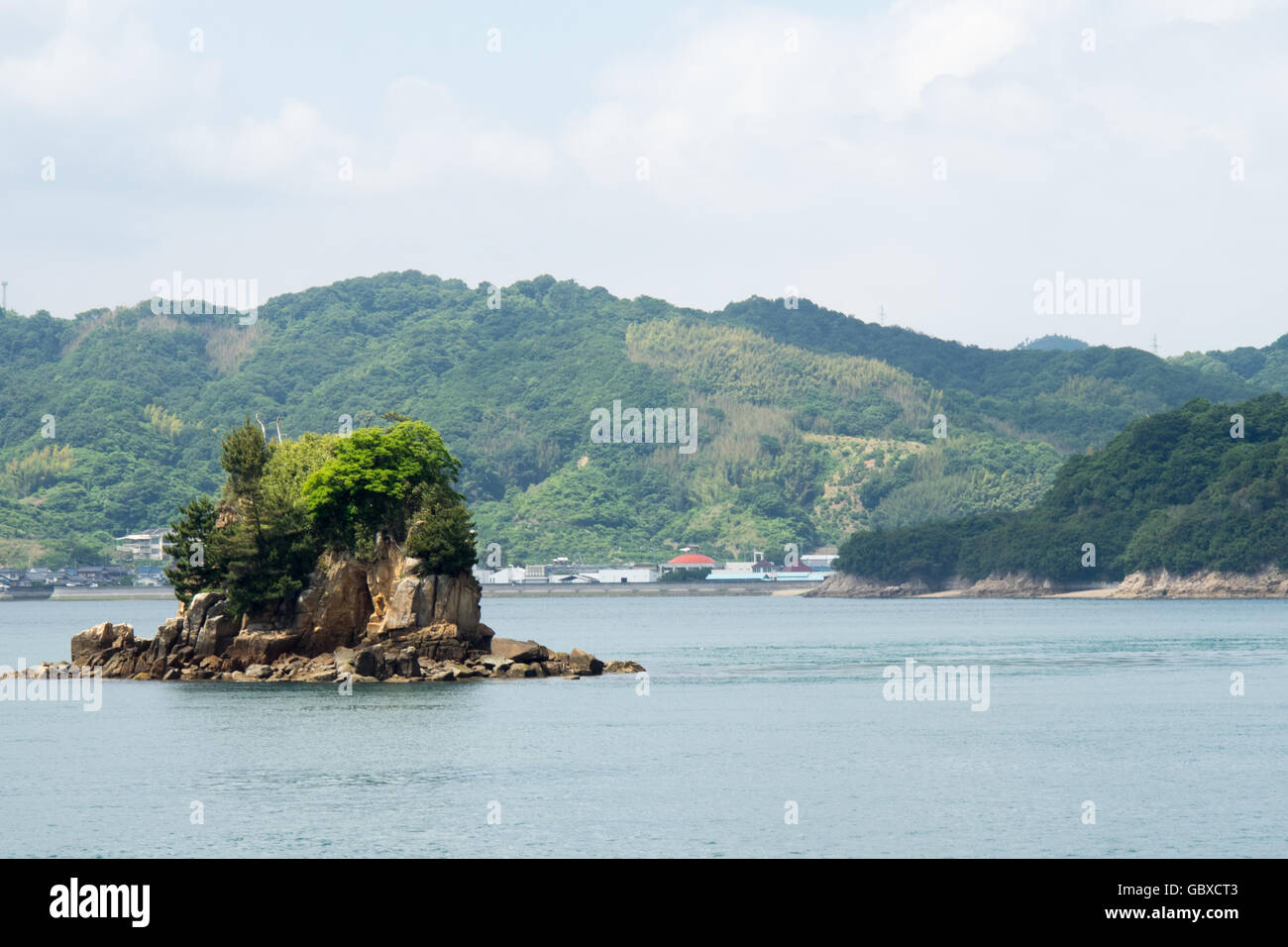 Un piccolo isolotto roccioso lungo la superstrada Nishiseto in Seto Inland Sea Foto Stock