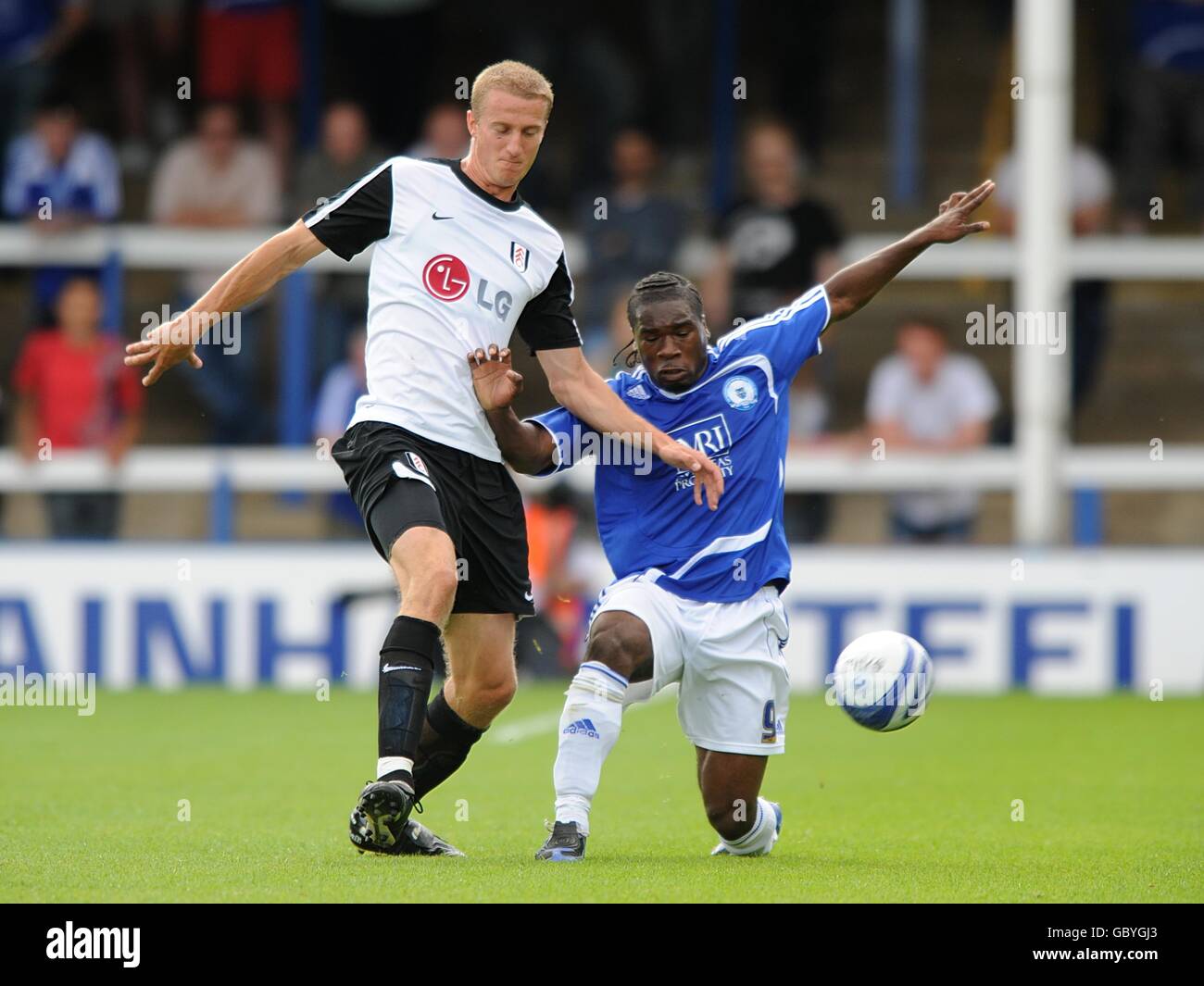 Calcio - Pre Season friendly - Peterborough United v Fulham - London Road. La Brede Hangeland di Fulham (a sinistra) e Aaron McLean del Peterborough United combattono per la palla Foto Stock