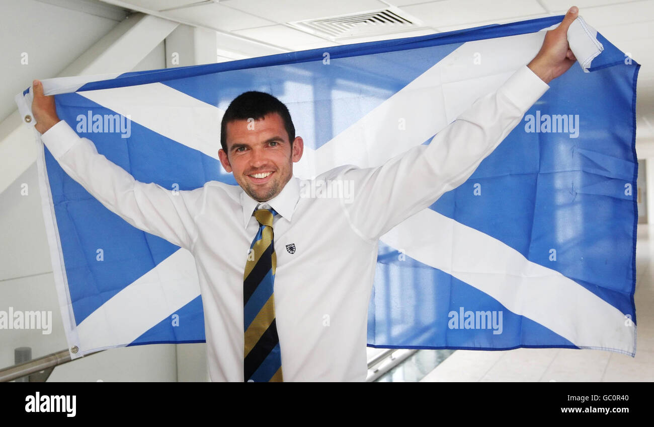 Il Callum Davidson della Scozia si pone con la bandiera nazionale all'aeroporto di Glasgow, Glasgow. Foto Stock