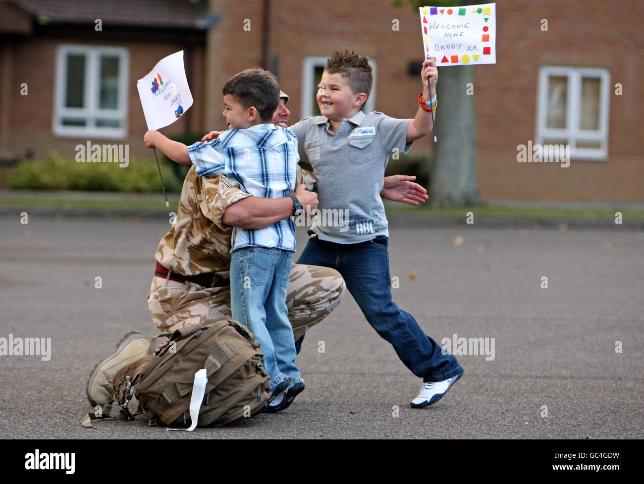 Il sergente Kevin Vaughan è accolto dai suoi figli Owen, Five, left, e Bradley, 6, Come 75 Regio ingegnere e Royal Logistic Corps bomba smaltimento e ricerca specialisti tornare a Carver Barracks, Wimbish, Essex dopo sei mesi in Afghanistan. Foto Stock