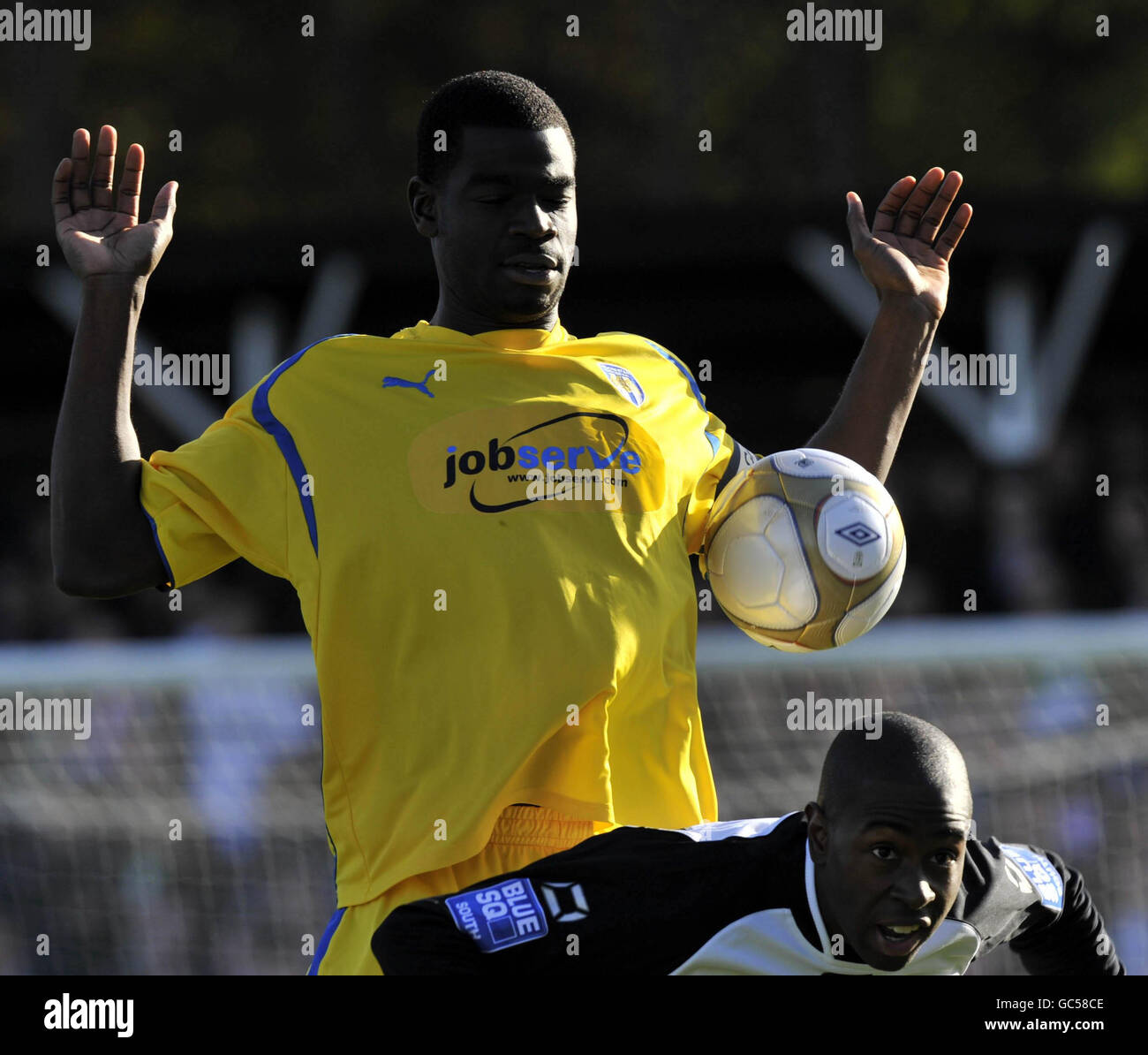 Magnus Okuonghae (indietro), capitano della Colchester United, e Warren McBean di Bromley durante la prima partita della fa Cup allo stadio di Bromley. Foto Stock