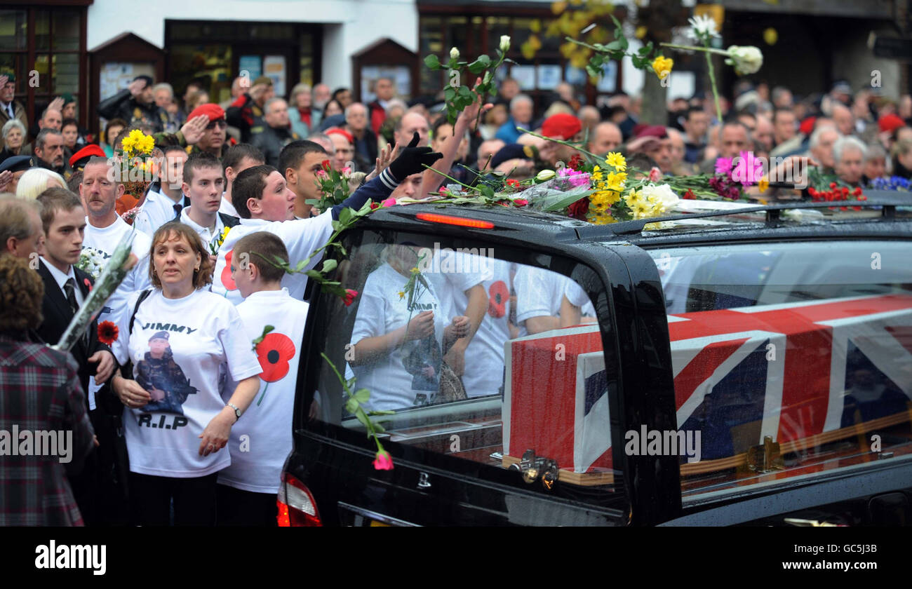 I cordoglio pagano i loro omaggi in qualità di barattoli di garanzia ufficiale Classe 1 Darren Chant, 40, Sergente Matthew Telford, 37, Guardsman Jimmy Major, 18, della Grenadier Guards, Corporal Steven Boote, 22, Corporal Nicholas Webster-Smith, 24, della Royal Military Police, E Serjeant Phillip Scott, 30 anni, dal 3° Battaglione i fucili passano attraverso il villaggio di Wootton Bassett nel Wiltshire durante il loro rimpatrio oggi. Foto Stock