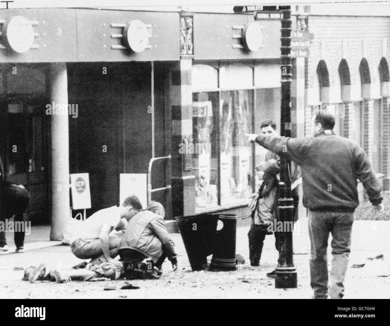 *CONTENUTO GRAFICO* UN GIOVANE GIACE PRESSO UNA PATTUGLIATRICE SUBITO DOPO L'ESPLOSIONE DELLA BOMBA NEL CENTRO DI WARRINGTON. Foto Stock