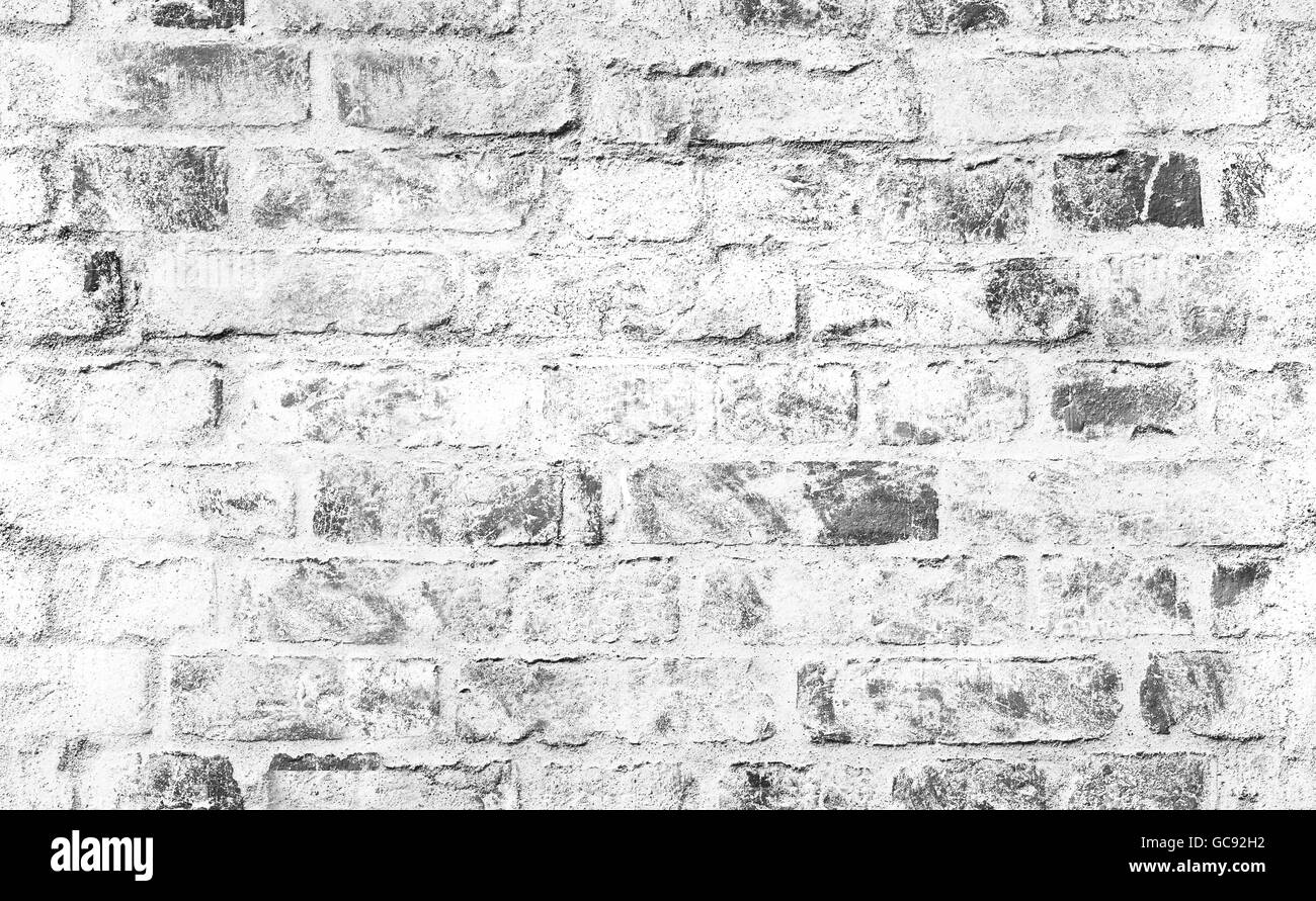 Il vecchio muro di mattoni con bianco danneggiato lo strato di vernice, closeup foto di sfondo texture. Composizione senza giunture Foto Stock