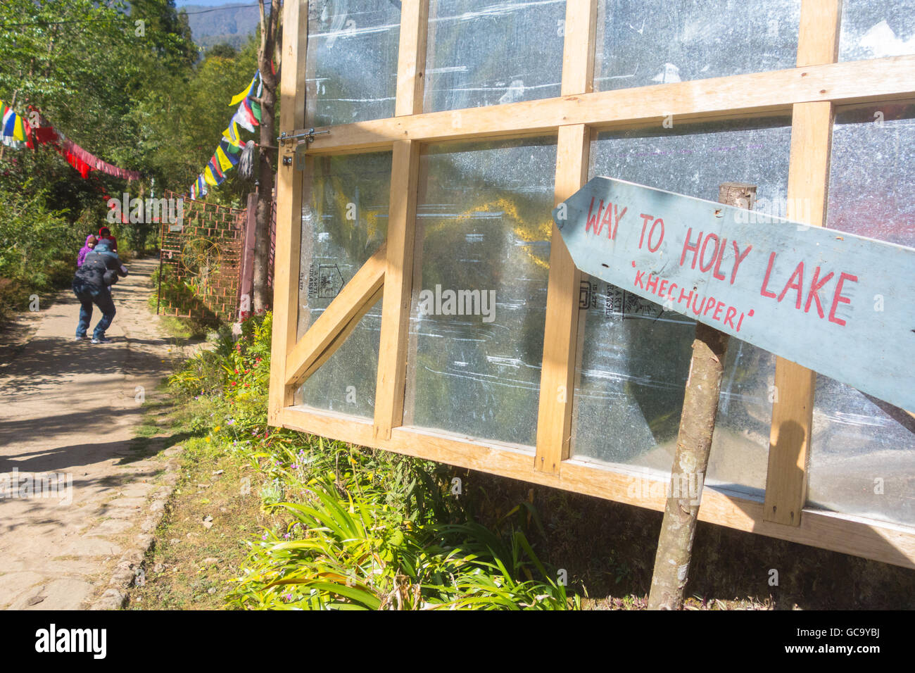 Cartello che mostra via al lago di Khecheopalri in ortografia, Sikkim, India Foto Stock