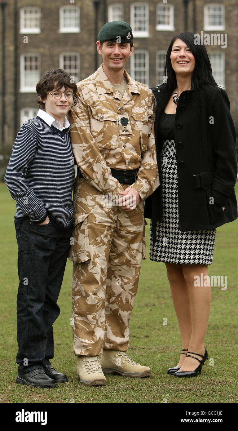 Warrant Officer Class 2 Peter Burney, che ha ricevuto una medaglia di gallantry della regina nella Lista dei premi operativi, con sua moglie Dawn e il figlio Jack dopo una cerimonia presso la Honourable Artillery Company, nel centro di Londra. Foto Stock