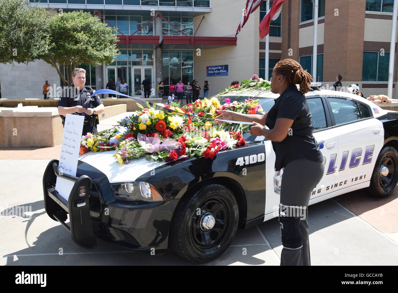 Dallas, Texas, Stati Uniti d'America. 8 Luglio, 2016. Dallas funzionari di polizia poco prima di mezzogiorno del 8 luglio 2016 decorare un auto della polizia al di fuori di Dallas questura con fiori donati dalla polizia e un locale Sam's Club store. Credito: Hum Immagini/Alamy Live News Foto Stock