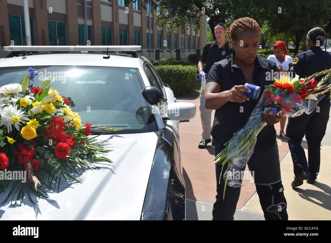 Dallas, Texas, Stati Uniti d'America. 8 Luglio, 2016. Dallas funzionari di polizia poco prima di mezzogiorno del 8 luglio 2016 decorare un auto della polizia al di fuori di Dallas questura con fiori donati dalla polizia e un locale Sam's Club store. Credito: Hum Immagini/Alamy Live News Foto Stock