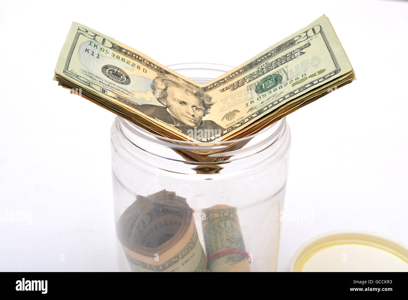 Di dollari andando in una giara denaro, il concetto di risparmio. Foto Stock