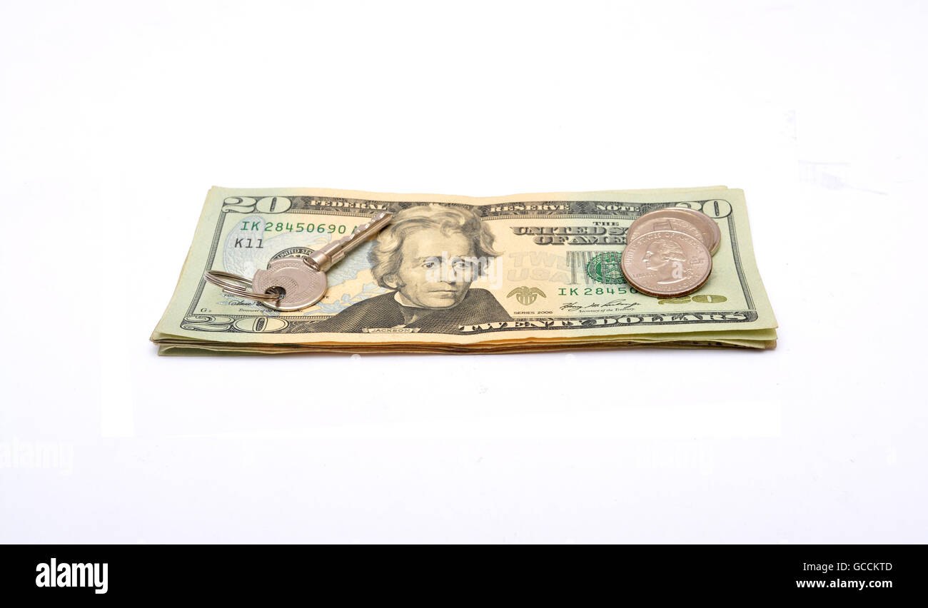 Tasto sulla parte superiore del dollaro di banconote e monete. Foto Stock