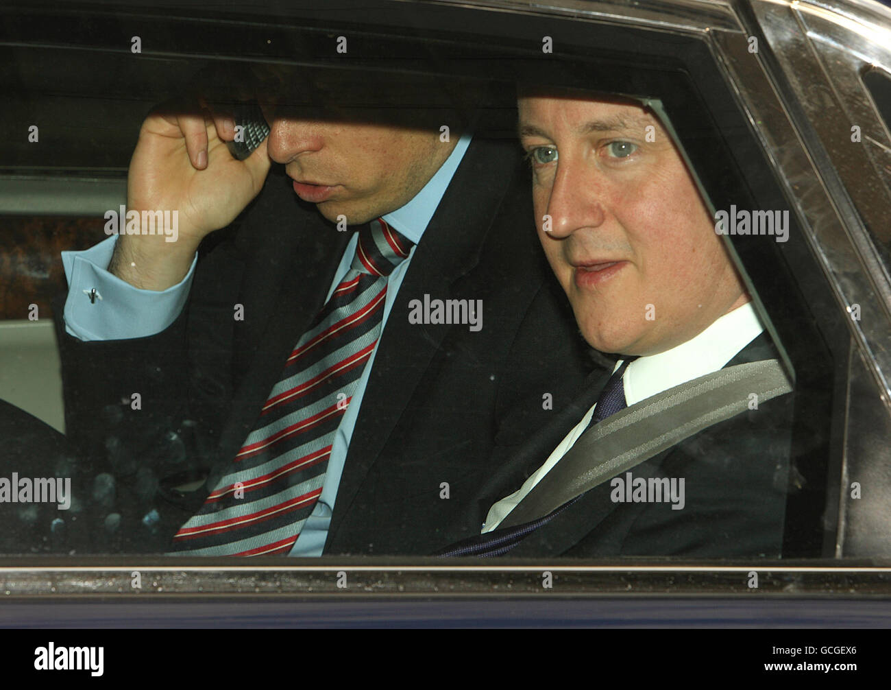 Il primo ministro David Cameron nella sua Jaguar ufficiale, mentre attende nel traffico a seguito di una visita al Dipartimento dell’energia e del cambiamento climatico, a Westminster, Londra. Foto Stock