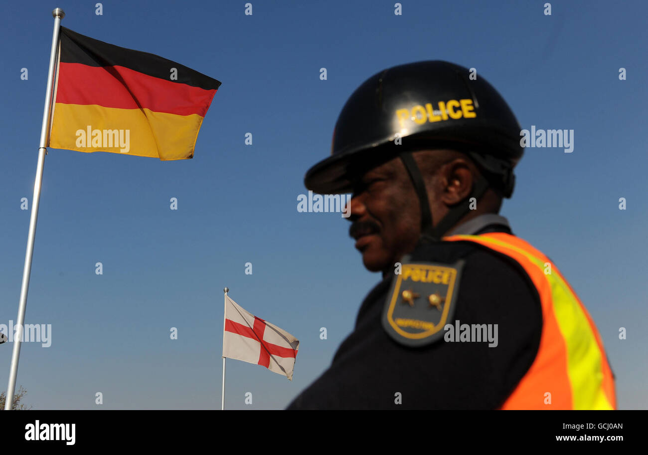 Un poliziotto passa davanti alle bandiere dell'Inghilterra e della Germania presso il centro stampa di Rustenberg, in Sud Africa. Foto Stock