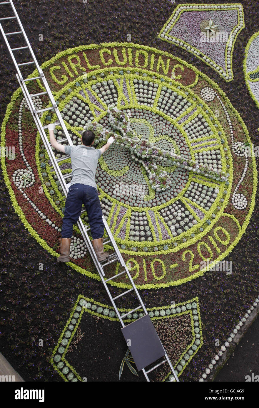 Un giardiniere mette il tocco finale al Floral Clock in Princes Street Gardens a Edimburgo. Foto Stock