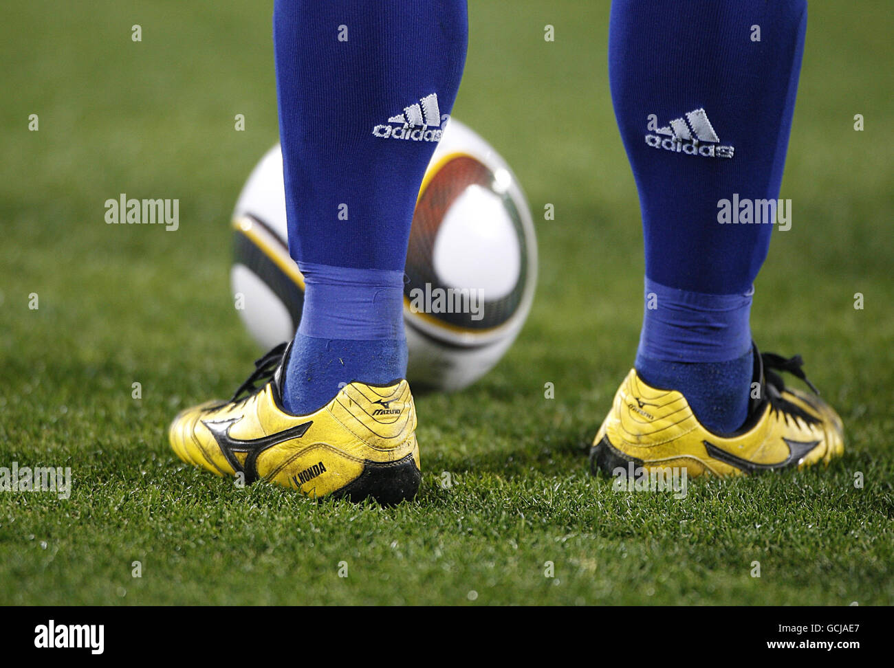 Vista generale di un giocatore giapponese con scarpe da calcio gialle Con  una palla Jabulani ai suoi piedi Foto stock - Alamy