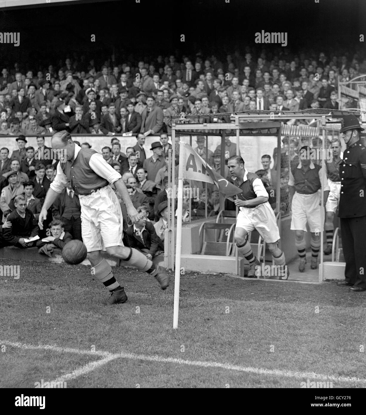 George Male, capitano dell'Arsenale e lasciato indietro, conduce fuori la sua squadra a Highbury. Foto Stock