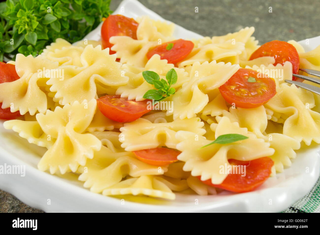 Il filtro Bow tie farfalle di pasta cucinati e serviti su una piastra Foto Stock