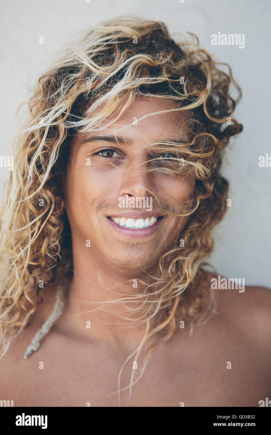 Ritratto di giovane surfista ispanica sbiancata con capelli biondi. Foto Stock