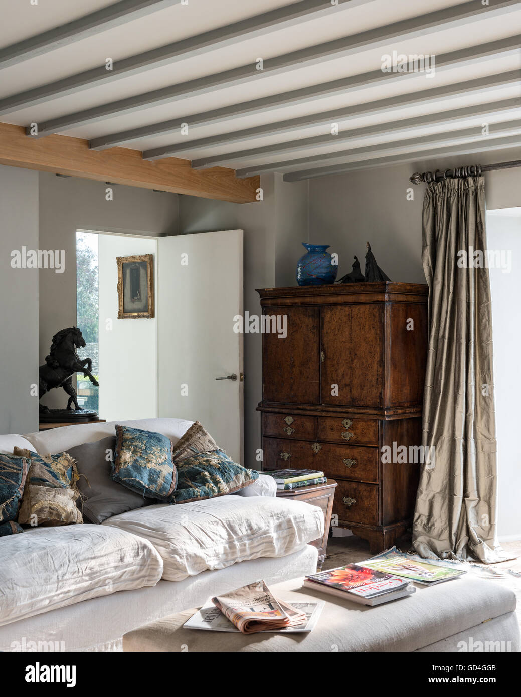 Antico armadio in legno e la statua equestre di biancheria da letto e da bagno divano nel soggiorno accogliente Foto Stock