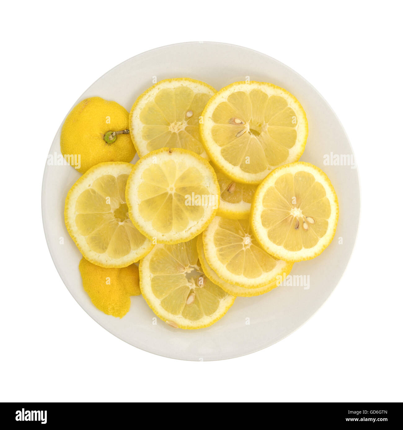 Vista dall'alto di una fetta di limone fresco su una piastra bianca isolata su uno sfondo bianco. Foto Stock