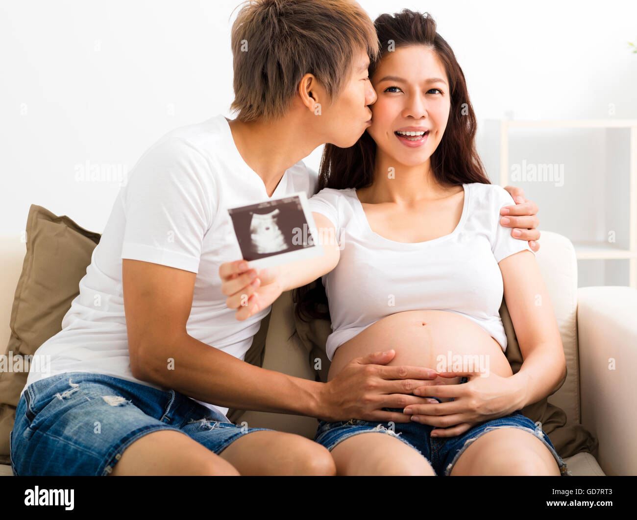 Felice di gravidanza e il marito che mostra immagine ad ultrasuoni Foto Stock