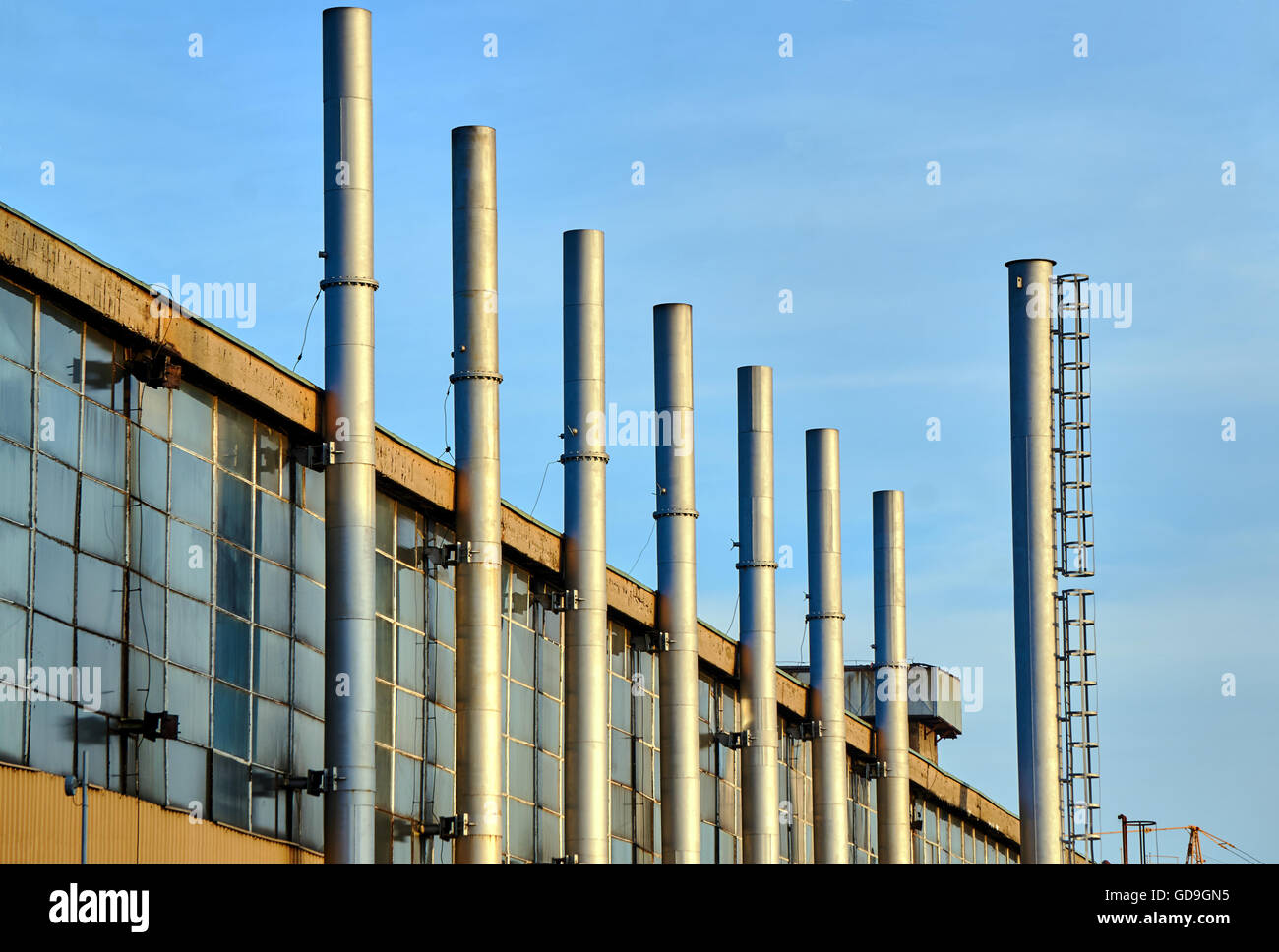 Frammento di edificio in fabbrica con camini in acciaio Foto Stock