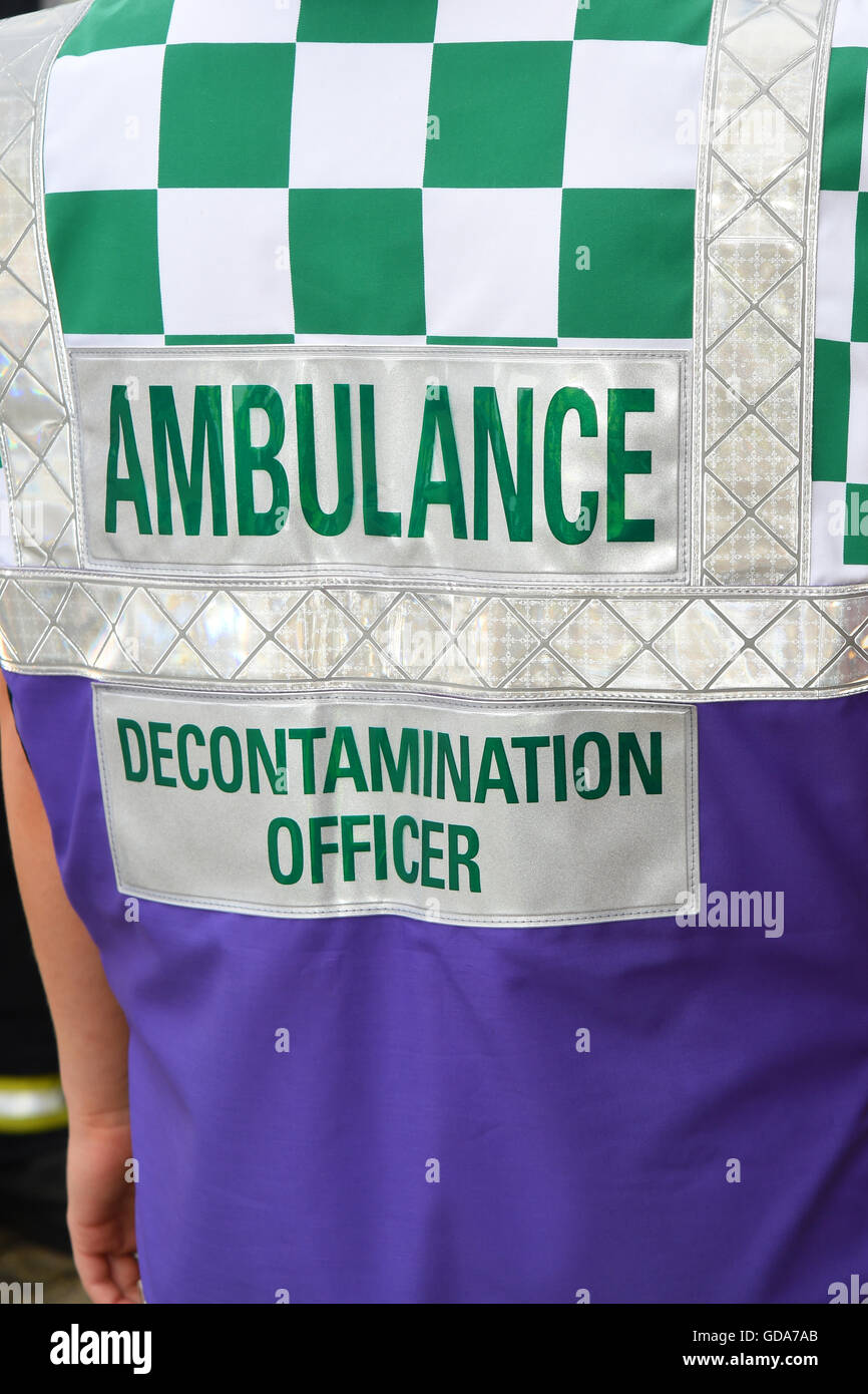 La decontaminazione di ambulanza officer presso la scena di un incidente Foto Stock