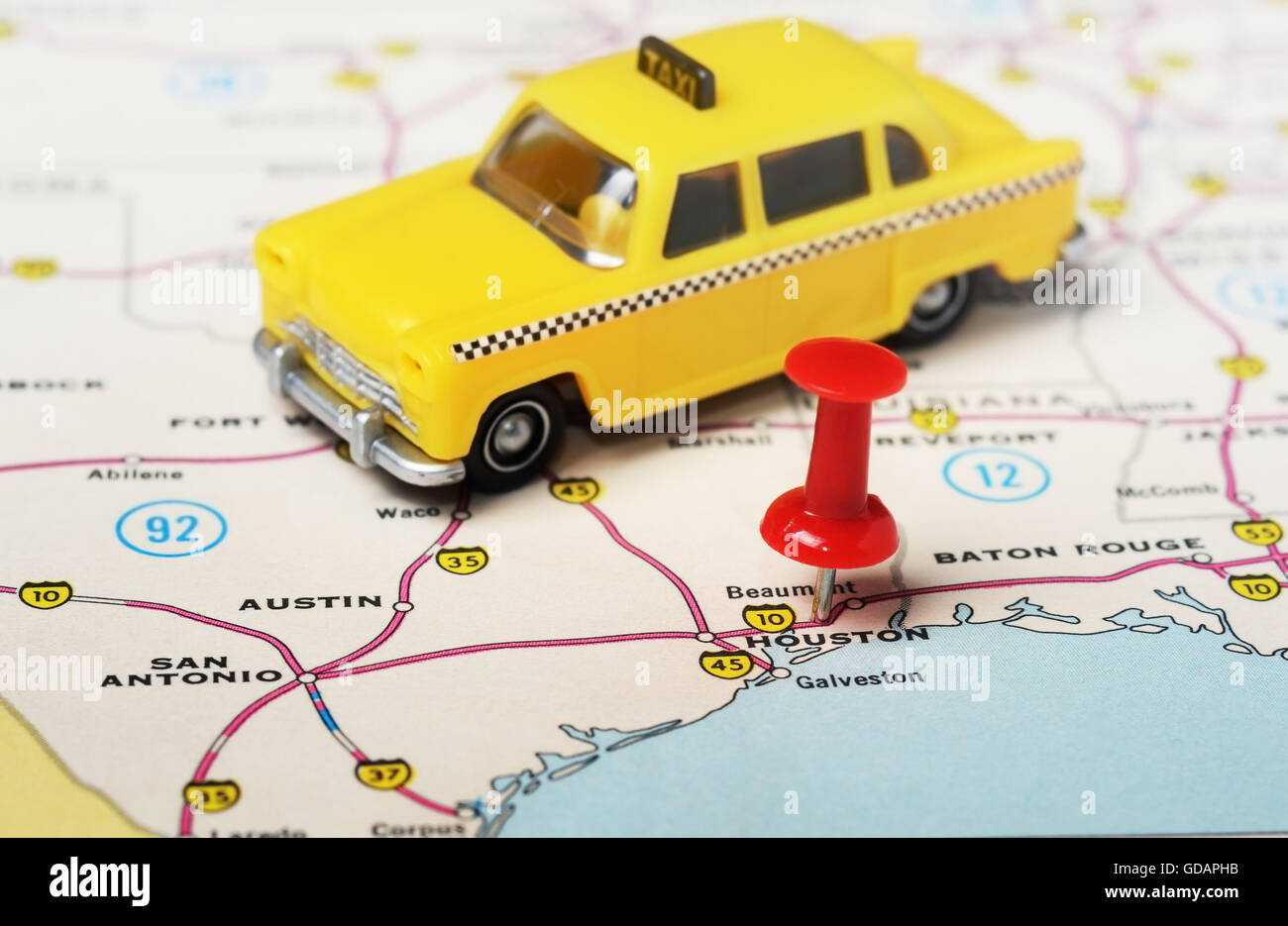 Close up di Houston USA mappa con perno rosso e taxi auto giocattolo - Concetto di viaggio Foto Stock