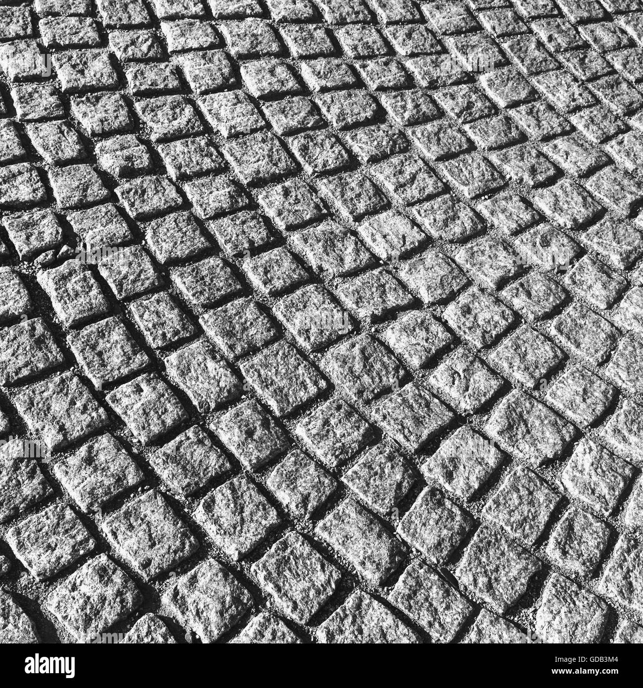 Grigio scuro strada acciottolata marciapiede con rotondi, urban texture di sfondo Foto Stock