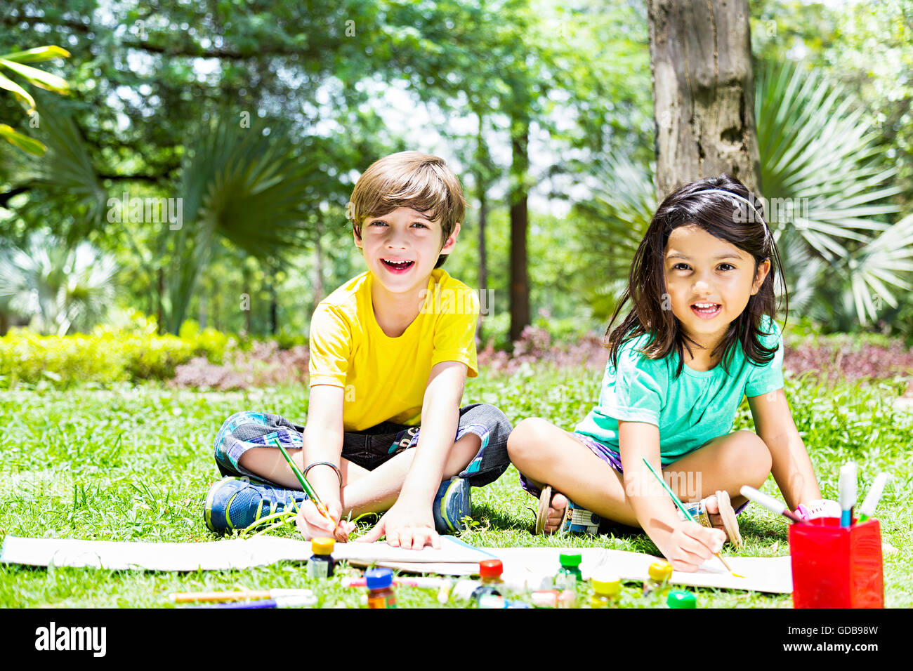 2 bambini indiani ragazzo e una ragazza amici studenti parco pittura disegno Foto Stock