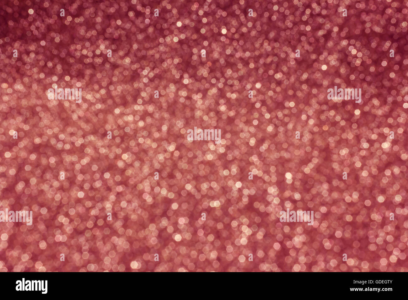 Bokeh piccola scintilla di luce che rifulge sul pastello rosa soft sfondo rétro Foto Stock