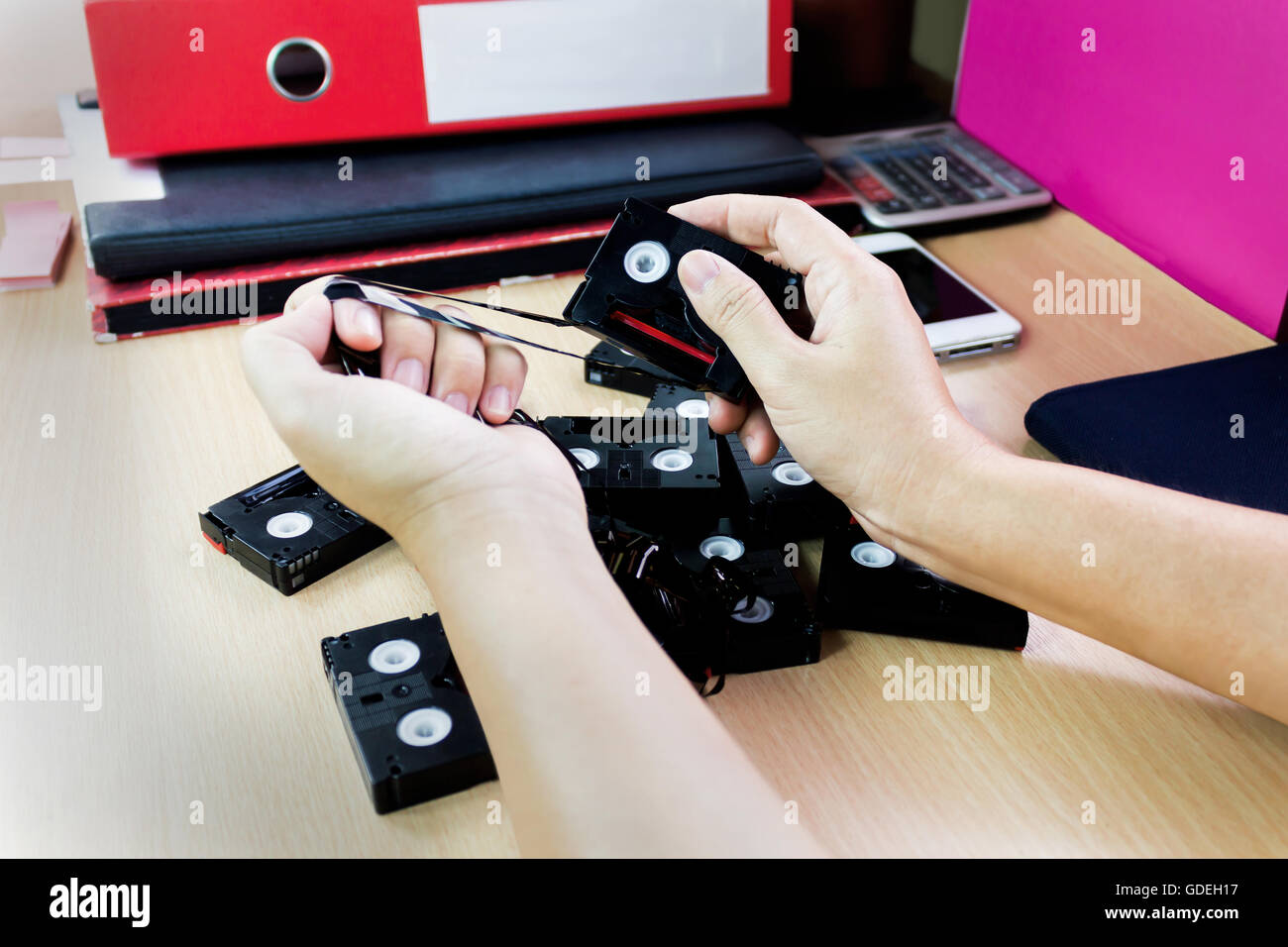 Mano distruggere cassetta mini DV ,concetto idea di eliminare elementi di prova Foto Stock