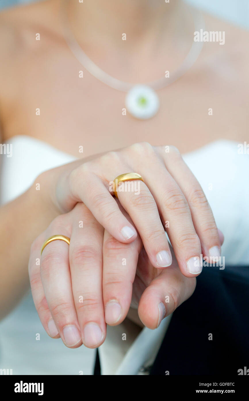 Le mani di una sposa e lo sposo, gli anelli di nozze Foto Stock