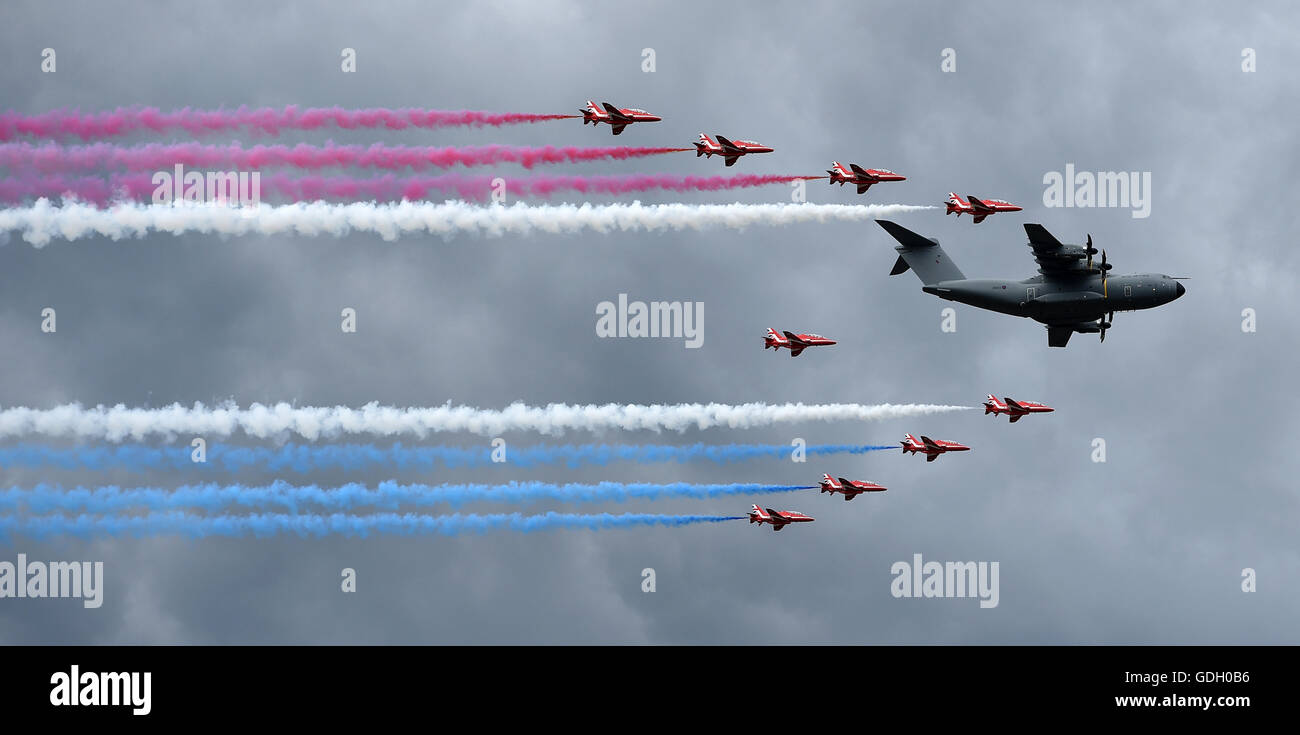 Le frecce rosse volare in formazione al fianco di un Royal Air Force Airbus A400M a Farnborough Airshow internazionale in Hampshire. Foto Stock