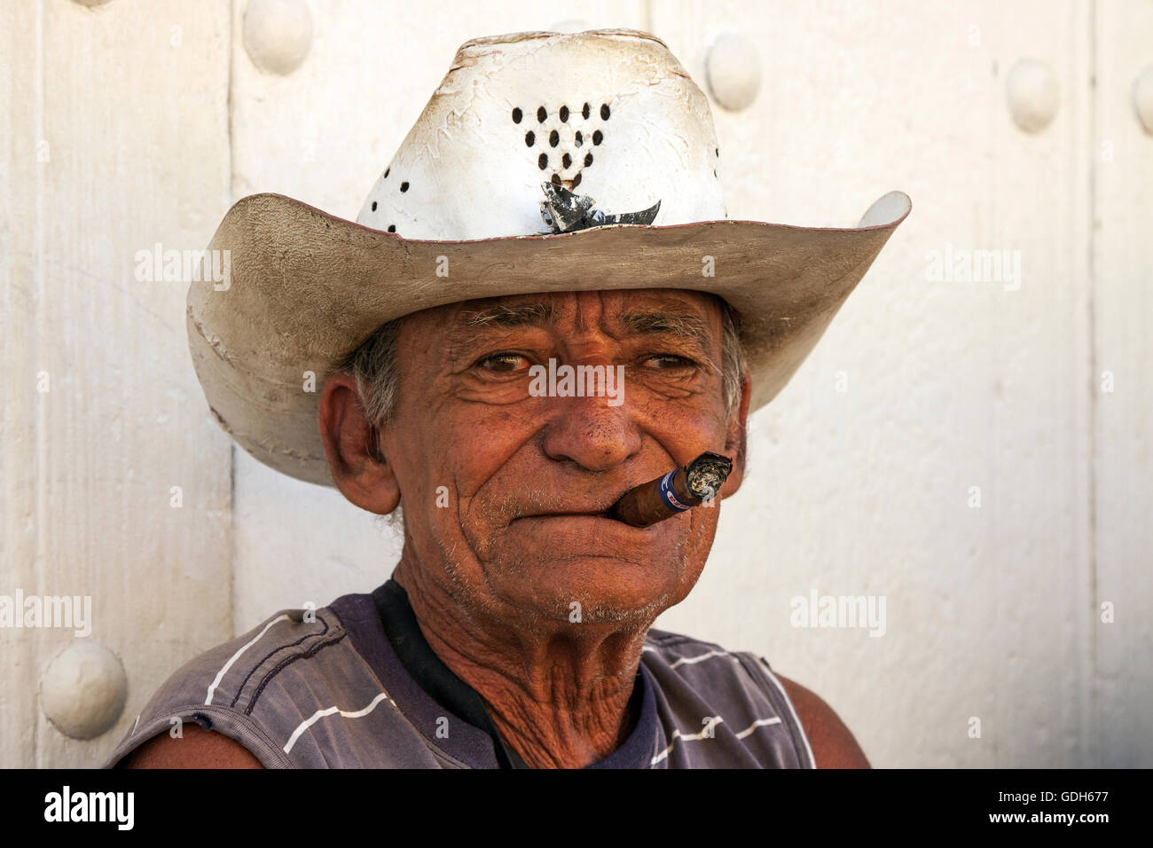 Il vecchio uomo cubano indossando cappello di paglia, fumare un sigaro, Trinidad, Cuba Foto Stock