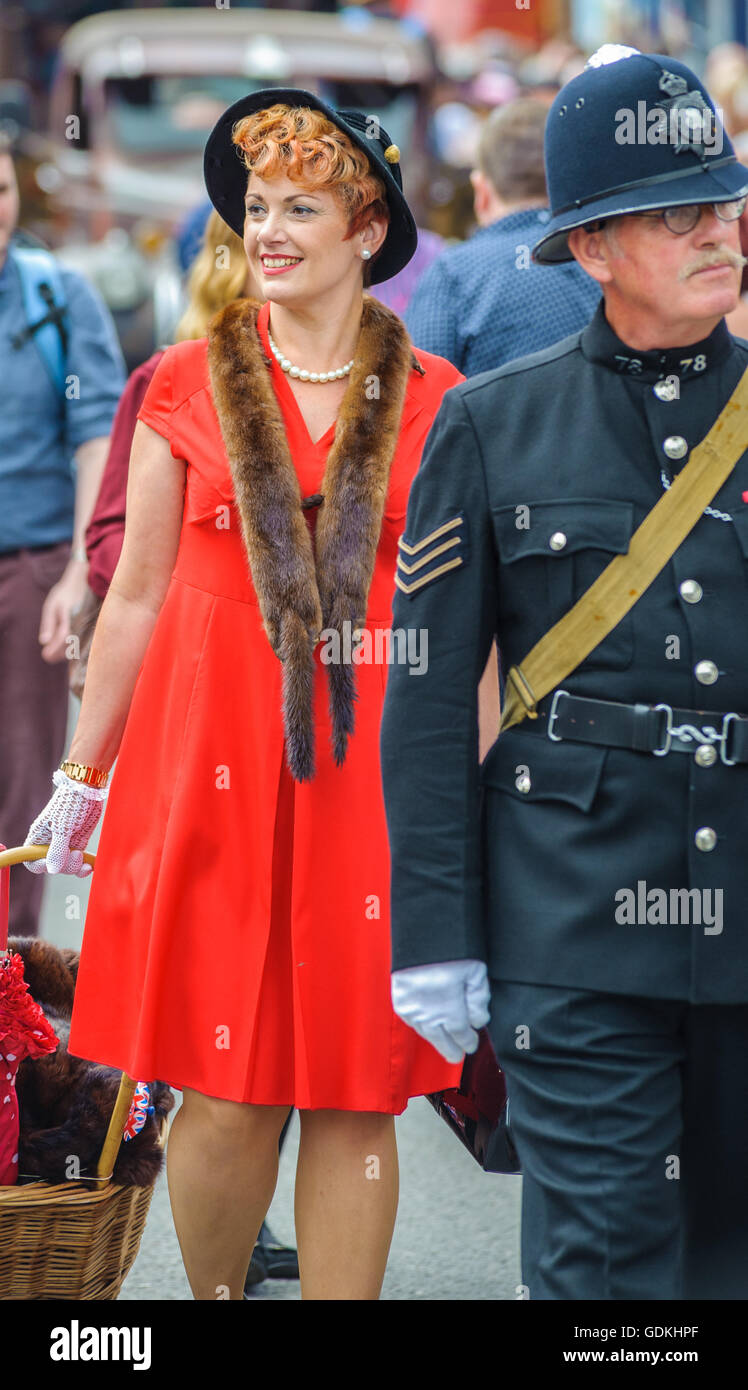 Woodhall Spa 1940 Festival - Donna vestita di 1940s stile con pelliccia di volpe e il cappello e il poliziotto Foto Stock