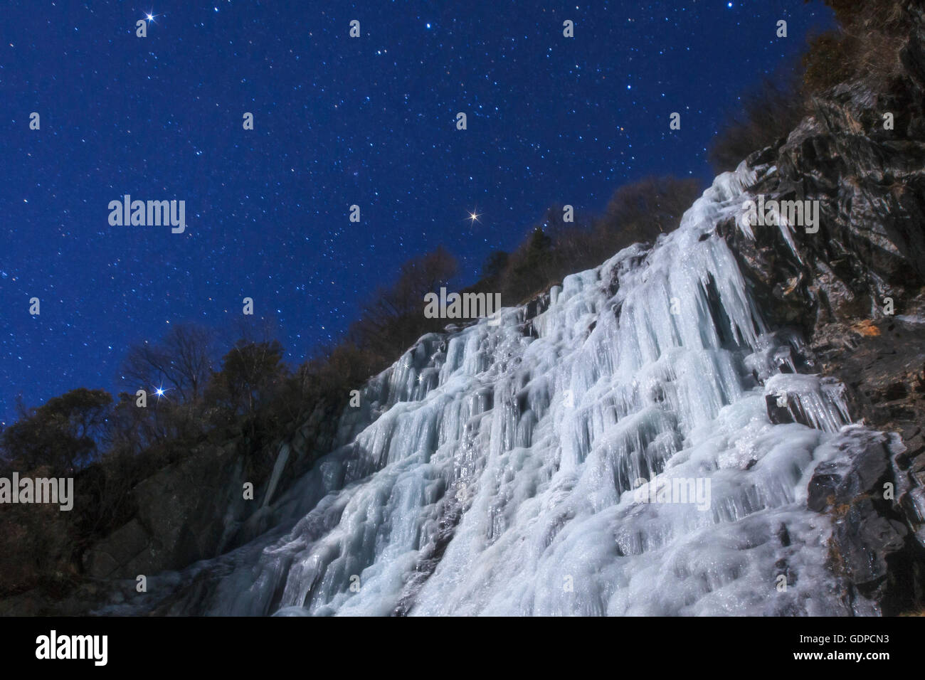 Stelle del triangolo invernale brillano al di sopra di un ghiacciaio in una notte di luna nella provincia di Sichuan della Cina. Foto Stock