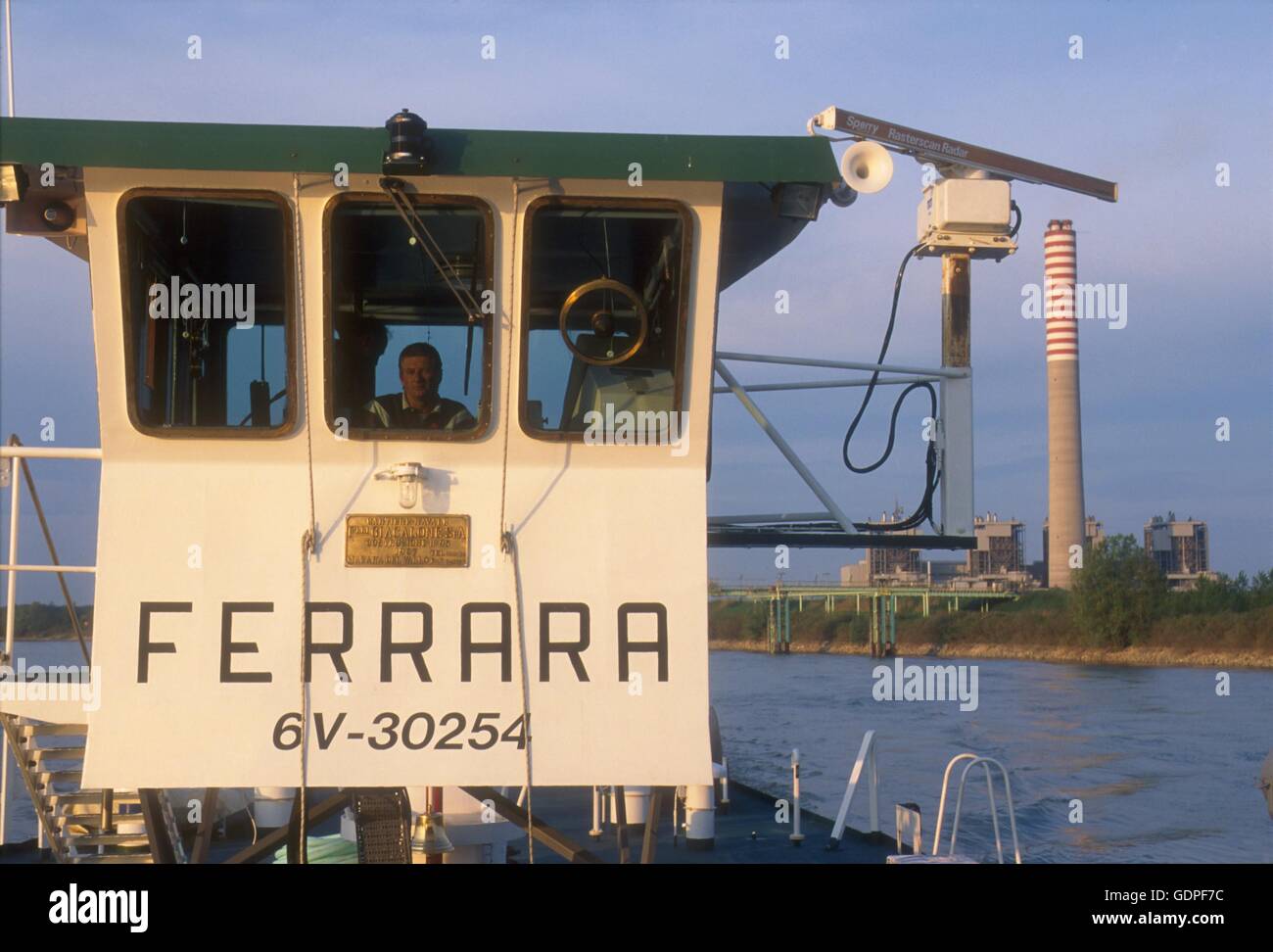Spintore la barca con una chiatta per il trasporto di merci in navigazione sul fiume Po (Italia) Foto Stock