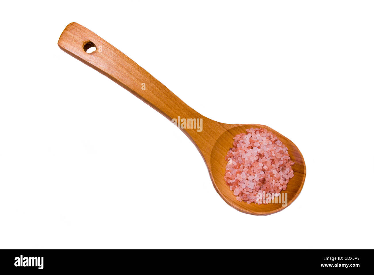 Il cucchiaio di legno di rosa Sale Himalayano su uno sfondo bianco visto da sopra Foto Stock