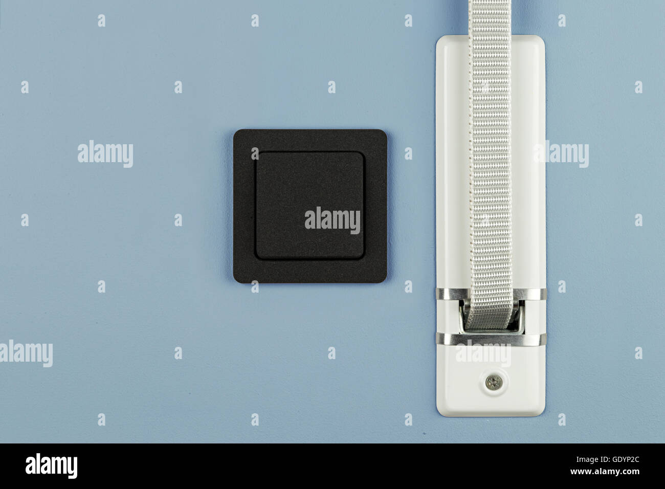 Cinghia di otturatore e interruttore luce,sulla parete blu Foto Stock