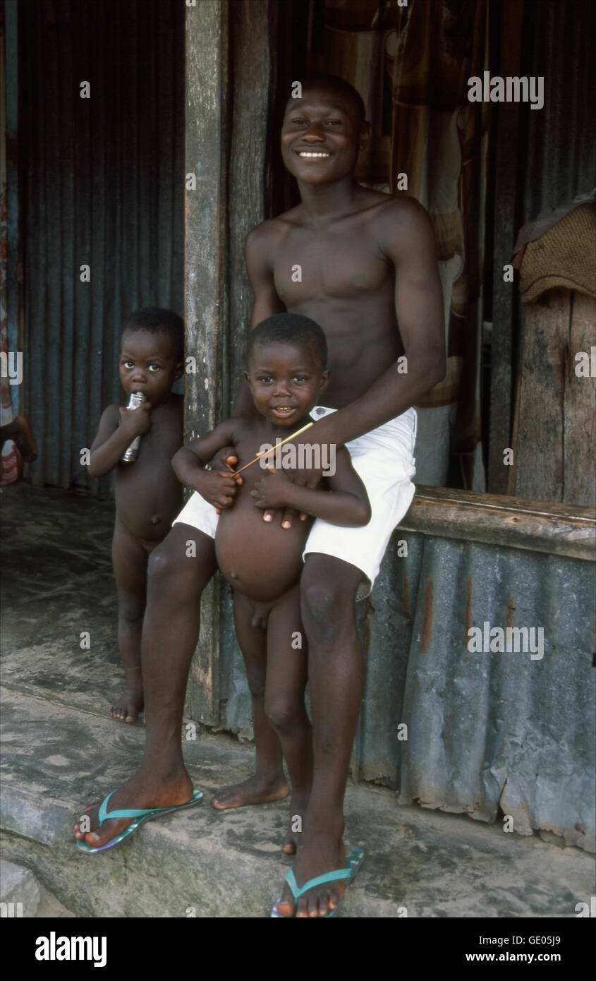 Un orgoglioso padre con i suoi due figli in Akassa, un villaggio sul fiume Nun in stato di Bayelsa, Nigeria. Foto Stock