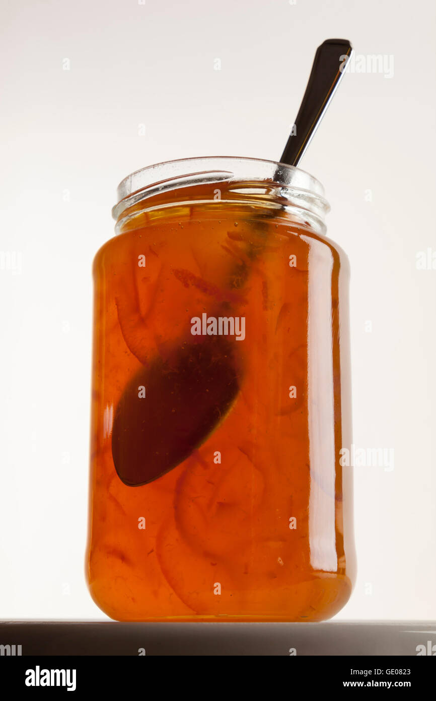 Un vasetto di marmellata di arance e cucchiaio Foto Stock