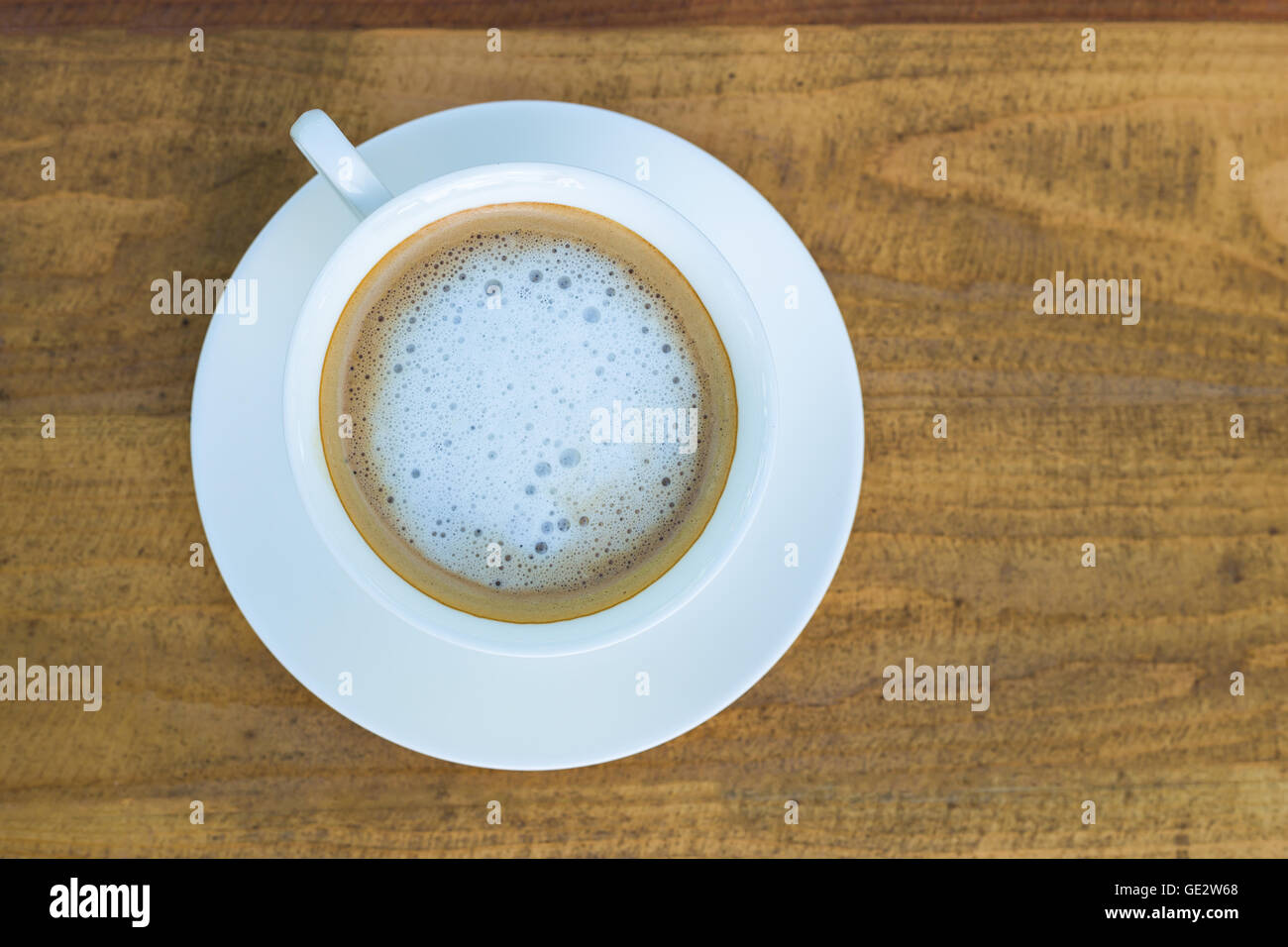 Cappuccino in tazza bianca su sfondo legno Foto Stock