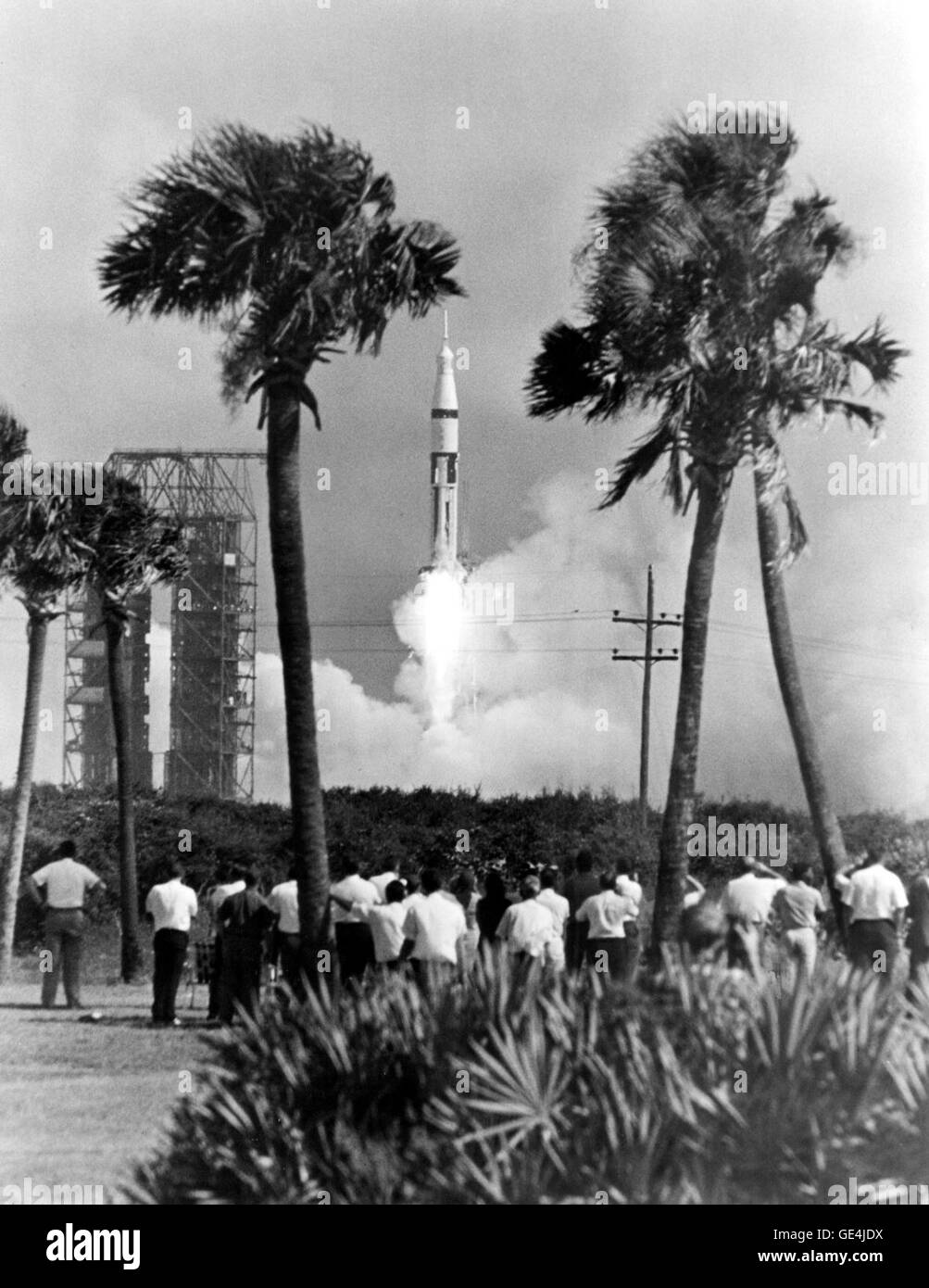 Questa fotografia storica cattura i lavoratori di Cape Kennedy che osservano il lancio di un razzo Saturn 1B. L'immagine riflette l'emozione e il successo tecnologico del programma spaziale statunitense durante i primi anni della corsa allo spazio, evidenziando il ruolo del Saturn 1B nell'esplorazione spaziale. Foto Stock