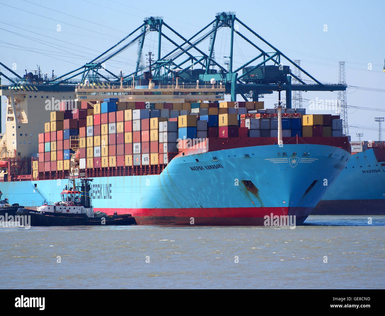 La Maersk Kawasaki è una nave container costruita nel 1979, identificata dal numero IMO 9107887 e dall'indicativo di chiamata SXFJ. È raffigurato nel porto di Anversa, un importante porto belga, che riflette il suo ruolo nel trasporto marittimo e commerciale globale. Foto Stock