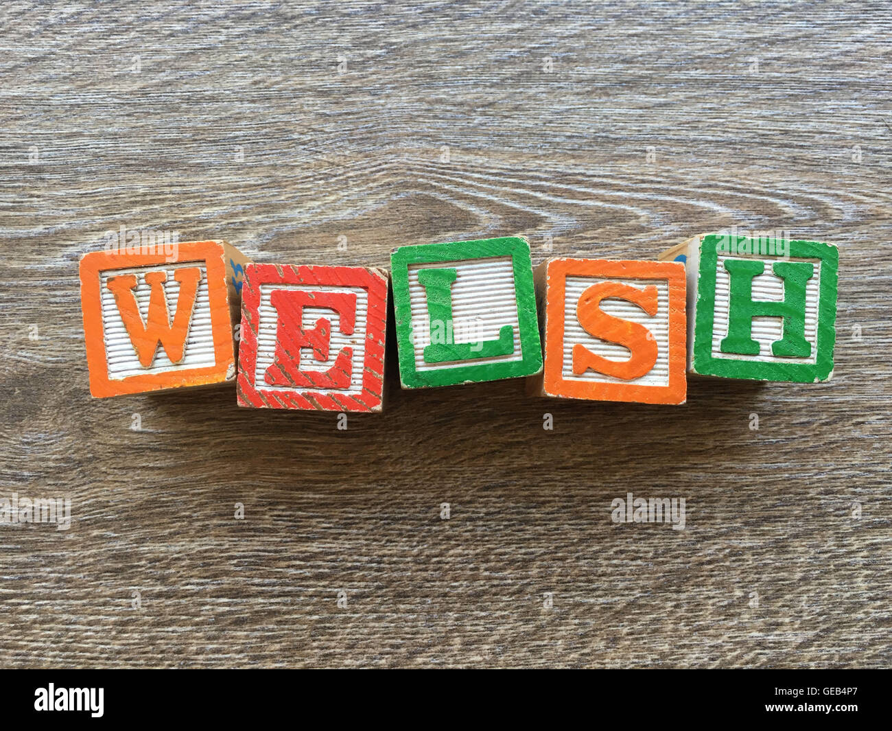 Alfabeto blocco di legno lettere che compongono la parola WELSH , unendo quei giocattoli lettere aiutare i bambini ad imparare e scrivere in inglese Foto Stock