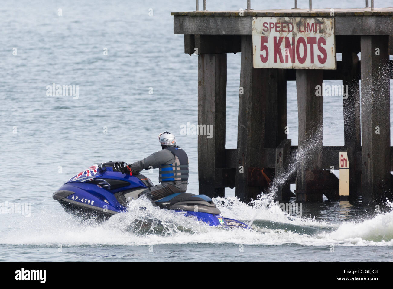 Un jet ski andando fuori del porto di entrata in Aberystwyth Foto Stock