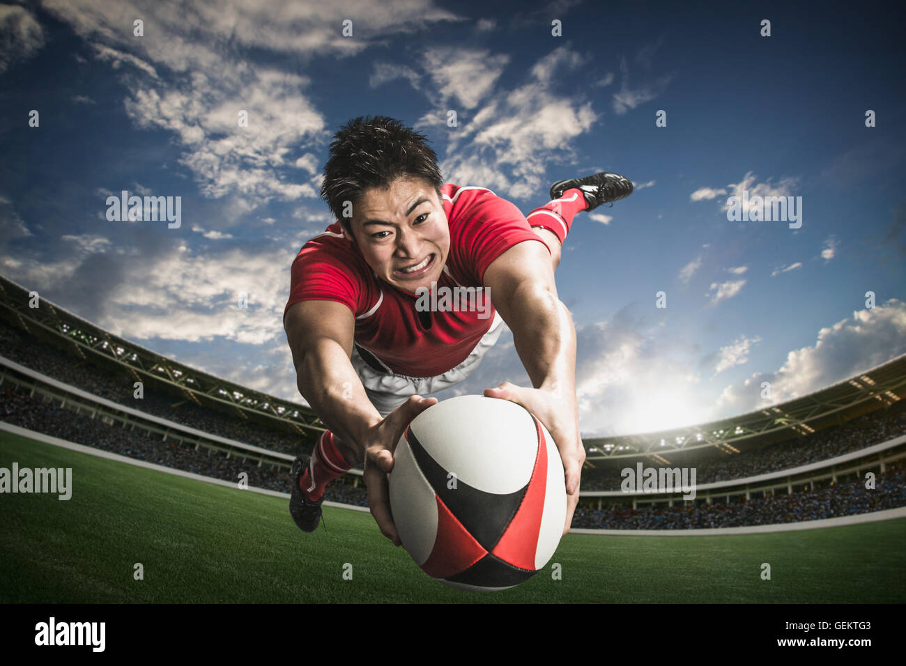 Ritratto di giapponese giocatore di rugby immersioni il cliente a provare Foto Stock