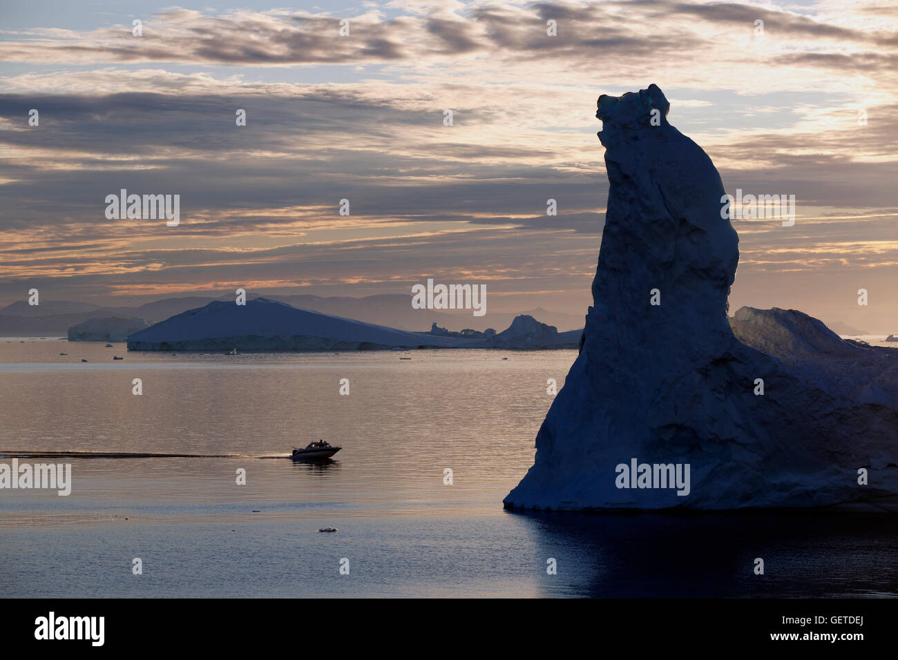 Barca e iceberg sotto il sole di mezzanotte, Disko Bay, Ilulissat Foto Stock