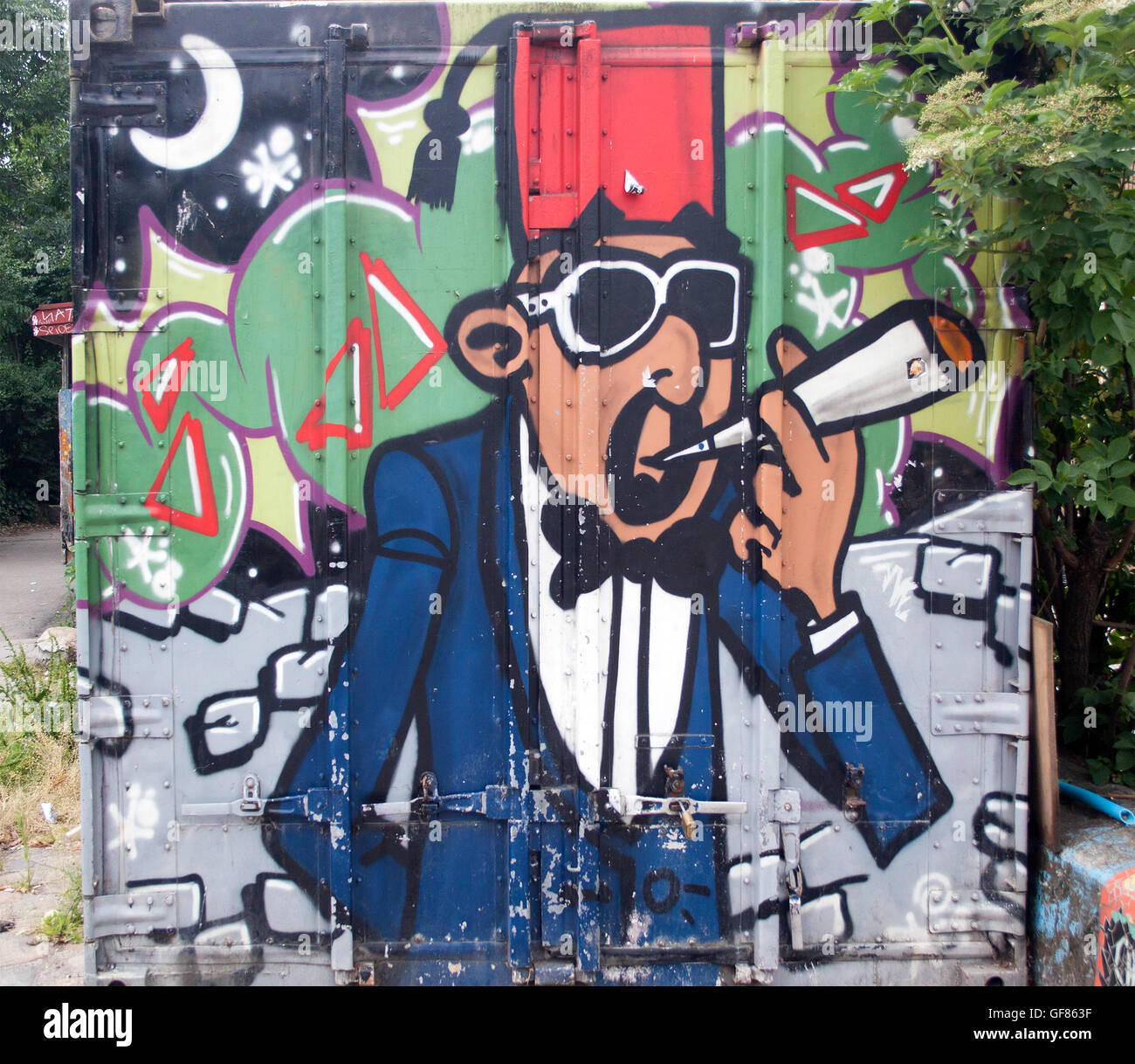Graffiti colorati coprono un muro a Freetown Christiania, Copenhagen, che mostra la vivace controcultura e la scena artistica di strada della zona. Foto Stock